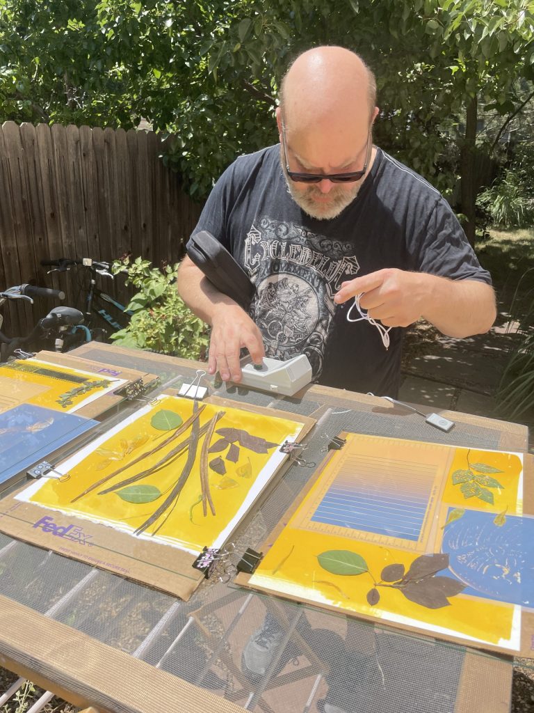 These simple contact frames worked fine. Here I am setting up an ultra violet light reader to measure the amount of exposure in our first round of tests. We found 45 minutes in the bright, Colorado, noon-day sun gave the best amount of exposure.